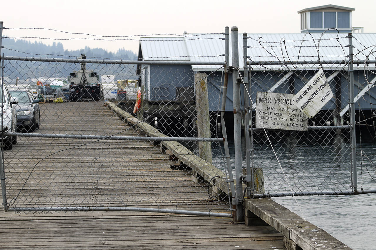 The entrance to the Cooke Aquaculture fish pens near the southern end of Fort Ward Park. Employees’ cars had been driven out onto the pier and the gates had been padlocked.                                Terryl Asla/Kitsap News Group