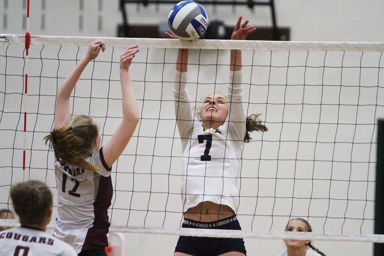The Spartans’ Erica Sprott elevates for a block against HNA. (Brian Kelly | Bainbridge Island Review)