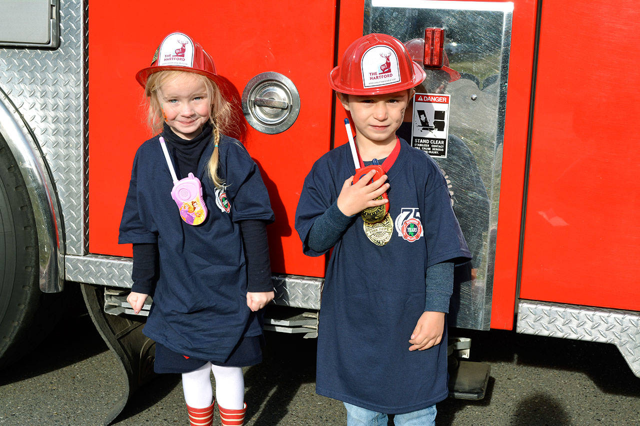 Hudson, 5, and Becca, 4, pose by the firetruck. (Mark Krulish/Kitsap News Group)