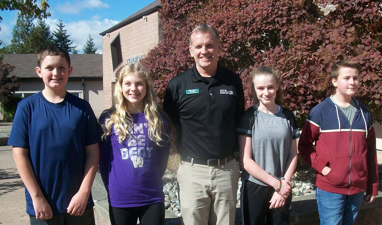 Photo courtesy of Woodward Middle School                                Students of the Month Lucas Wikstrom, Emma Solseng, Erin Weiss and Rowan Gano stand with WMS Principal Mike Florian.
