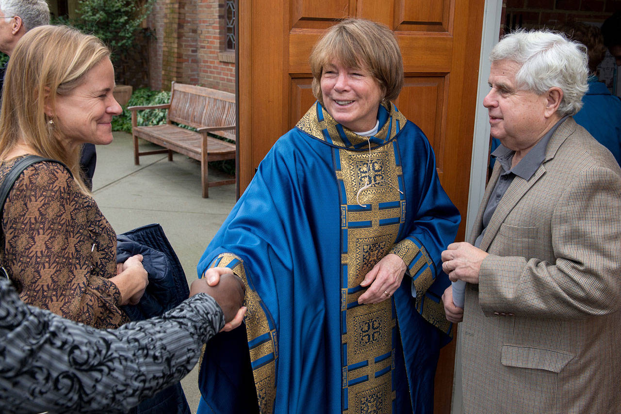 The Reverend Karen Haig greets parishioners at St. Barnabas Episcopal Church.