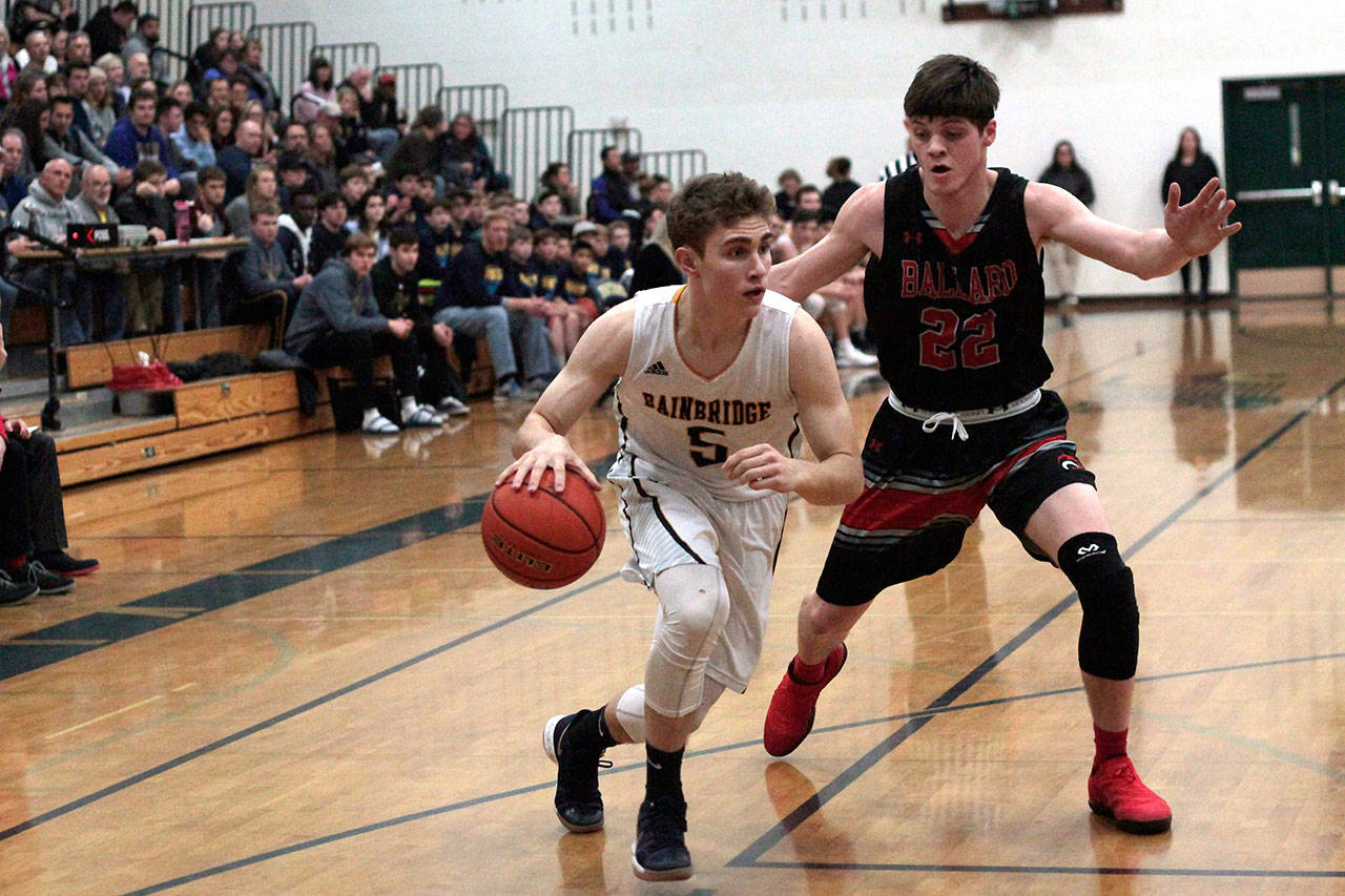 Luciano Marano | Bainbridge Island Review - Spartan sophomore Jonathan Kussie moves around a Ballard defender on his way to the hoop in Friday’s home game.