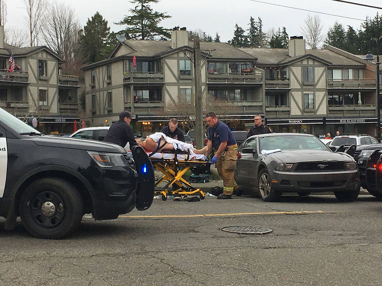 Medics take away a man who was shot Wednesday afternoon in downtown Winslow.