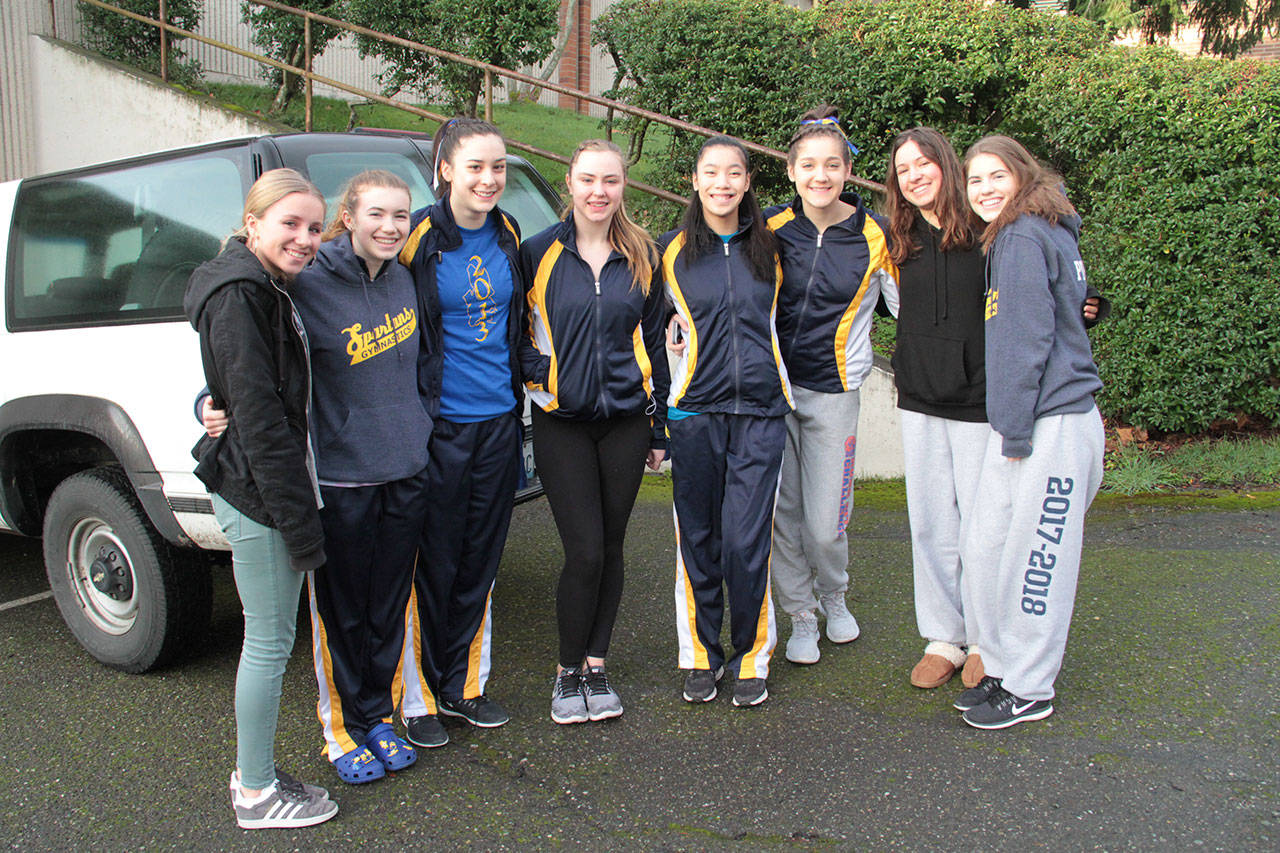 Members of the Bainbridge High gymnastics team gather for a group photo before leaving Thursday for the state championship meet in Tacoma. (Brian Kelly | Bainbridge Island Review)
