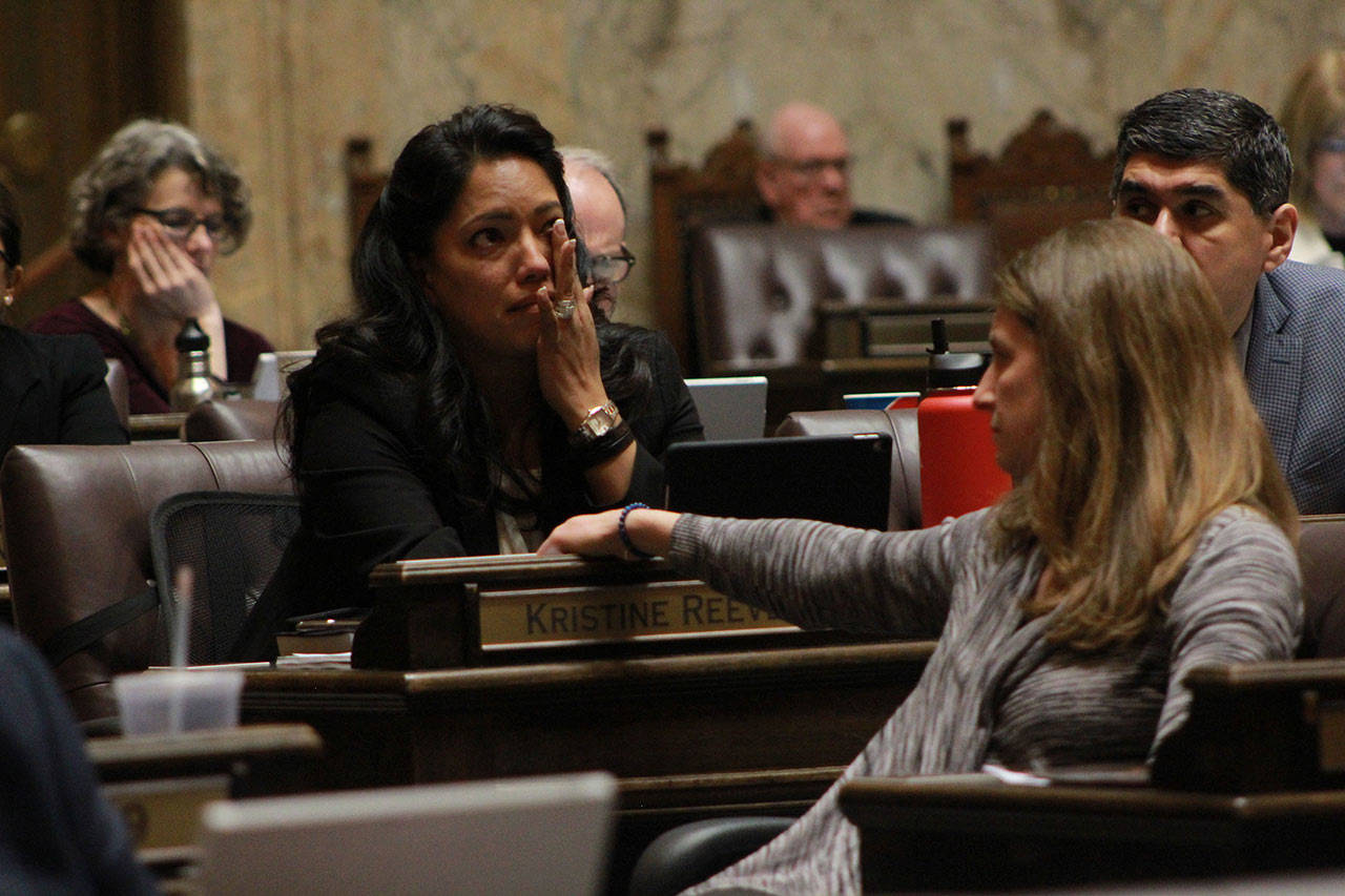 Rep. Kristine Reeves, D-Federal Way, battled tears during the House floor debate on a bill to ban bump stocks, while her colleague Tana Senn, D- Mercer Island, turned to comfort her. (Taylor McAvoy | WNPA Olympia News Bureau)