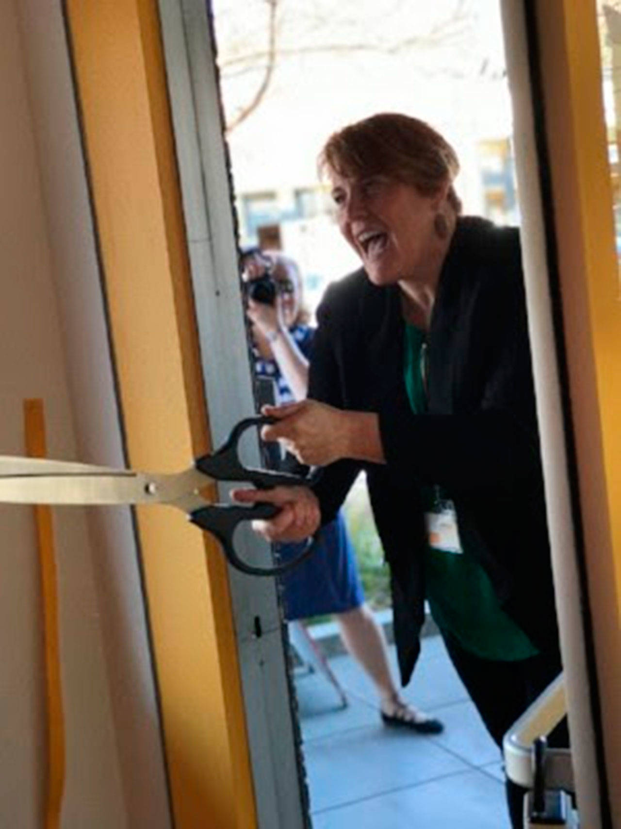 Photo courtesy of The Art Project | The Art Project’s executive director Lindsay Masters performs the ceremonial ribbon cutting as the downtown Winslow gallery is reopened after being remodeled and renamed.