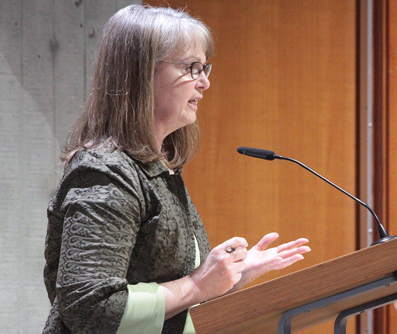Bainbridge council candidate Leslie Schneider answers questions from the council at Tuesday’s meeting. (Brian Kelly | Bainbridge Island Review)