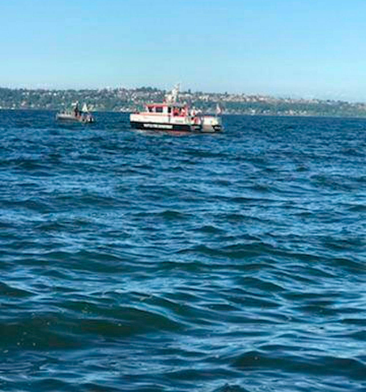 A Seattle Fire Department boat crew searches for a 70-year-old man who went missing after his plane crashed in the water off Bainbridge Island on May 27. (U.S. Coast Guard photo by Petty Officer 3rd Class Dustin Lay)