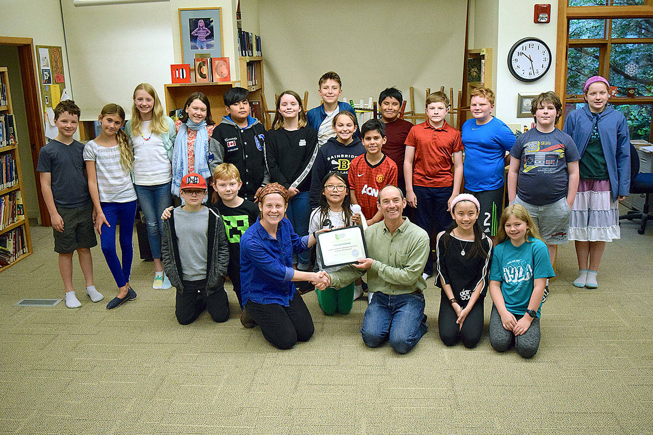 Becky Bronstein of Washington Green Schools presents the Sustaining Platinum certificate to Green Team teacher Mike Derzon and the 5th grade students. (Joan Henderson photo)