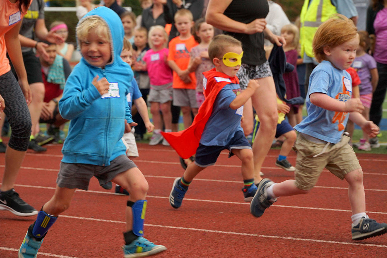 Luciano Marano | Bainbridge Island Review - R. J. Cox, 3, came bedecked in full super hero regalia to the year’s first Kiwanis All-Comers Track Meet Monday, July 9 at Bainbridge High School.