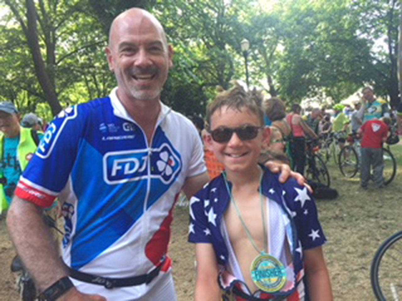 Photo courtesy of Jeffrey Roger | Jeffrey Roger and his son Julian, 10, stand together at the finish line of the 2018 Seattle to Portland bicycle ride.