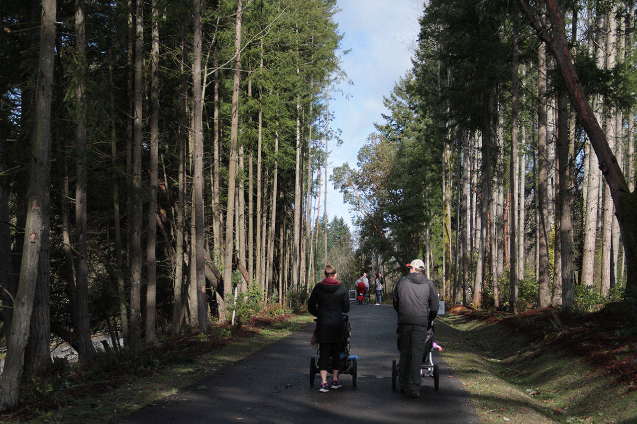 A couple pushes their baby carriages along the first leg of the Sound to Olympics Trail earlier this year. (Brian Kelly | Bainbridge Island Review file)