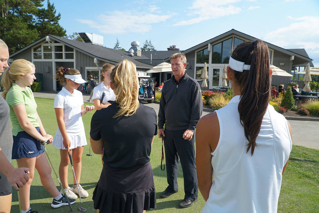 Luciano Marano | Bainbridge Island Review                                 Spartan Head Coach Ian Havill talks with the Bainbridge High School girls varsity golf team before practice earlier this week.