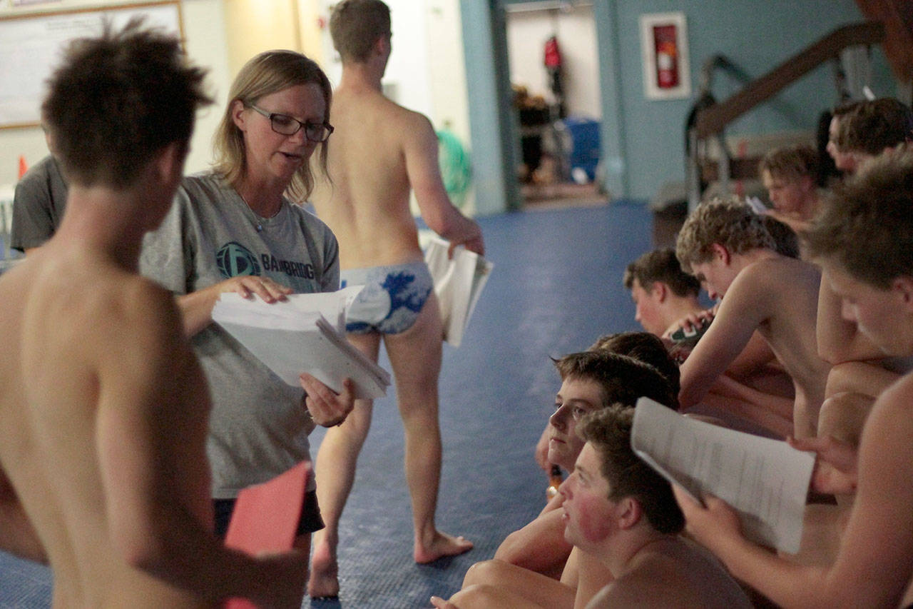 Luciano Marano | Bainbridge Island Review - Spartan boys varsity water polo team Head Coach Kristin Gellert hands out a list of game terms during an early season practice session.
