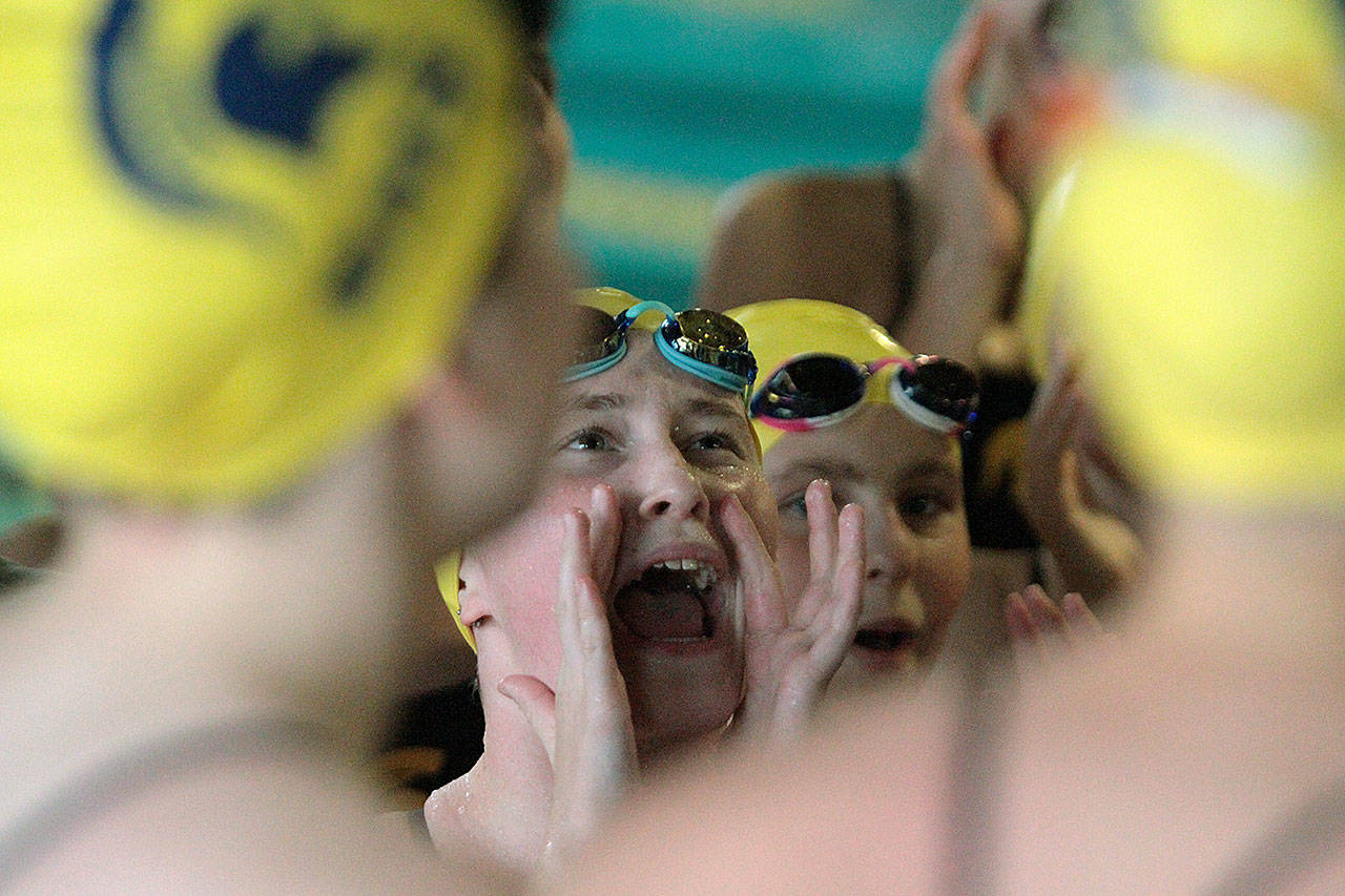 Spartan swimmers and divers do a team cheer before the start of the home meet against Ballard. (Brian Kelly | Bainbridge Island Review)