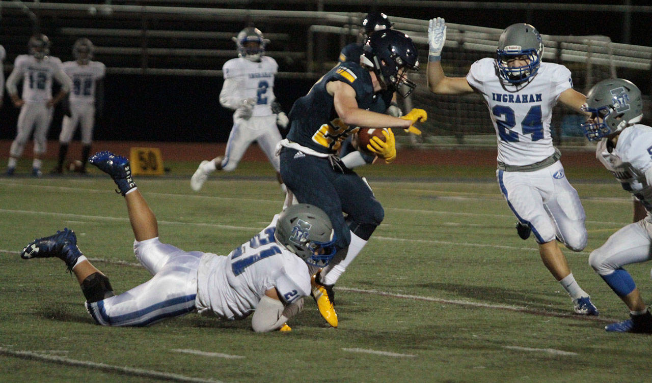 Max McLeod takes an Ingraham defender along for a ride as he picks up more yardage for the Spartans in Friday’s 44-22 win. (Brian Kelly | Bainbridge Island Review)