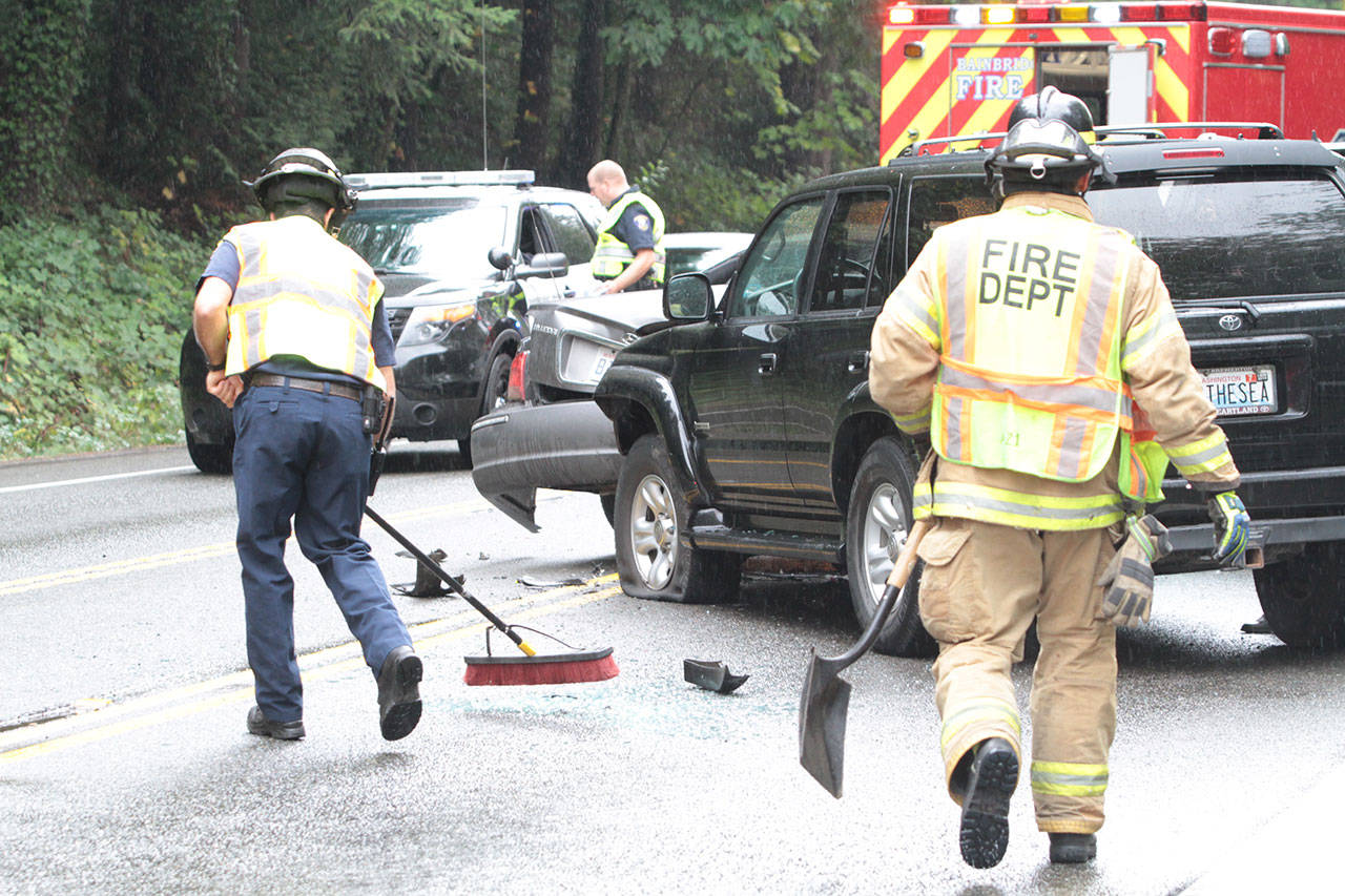 Bainbridge emergency responders clean up the roadway at the scene of a multiple-car collision on Highway 305. (Brian Kelly | Bainbridge Island Review)