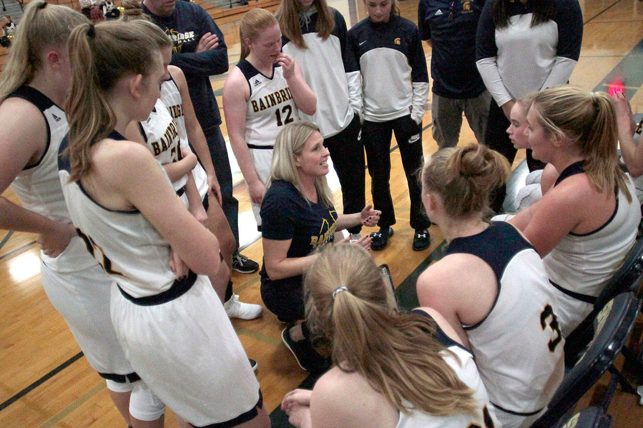 Luciano Marano | Bainbridge Island Review - Bainbridge High School varsity girls basketball team Head Coach Karen Byers, who took over the program from two-season honcho Henry Guterson, talks with the squad during Monday’s game.