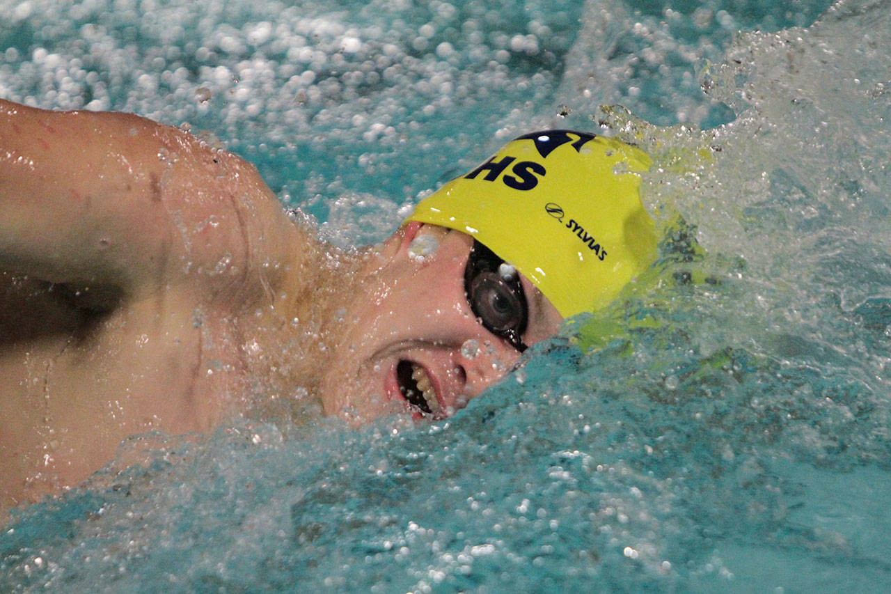 Sam Chapman swims in the 500-yard freestyle for Bainbridge during the Spartans’ matchup against Eastside Catholic. Chapman had a state-qualifying championship time in the race. (Brian Kelly | Bainbridge Island Review)
