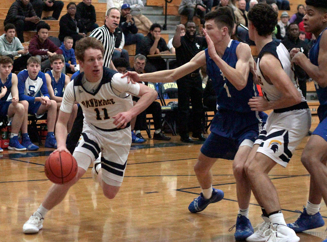 Luciano Marano | Bainbridge Island Review - Spartan senior Jackson Taylor drives around Seattle Prep defenders Tuesday. He led the team’s scoring efforts, putting up 14 points against the Panthers.