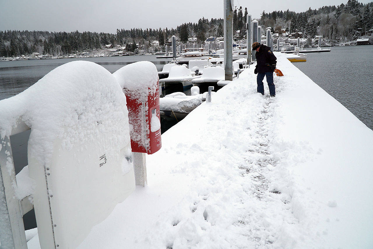 The city dock on Eagle Harbor is covered with snow Saturday. (Luciano Marano | Bainbridge Island Review)