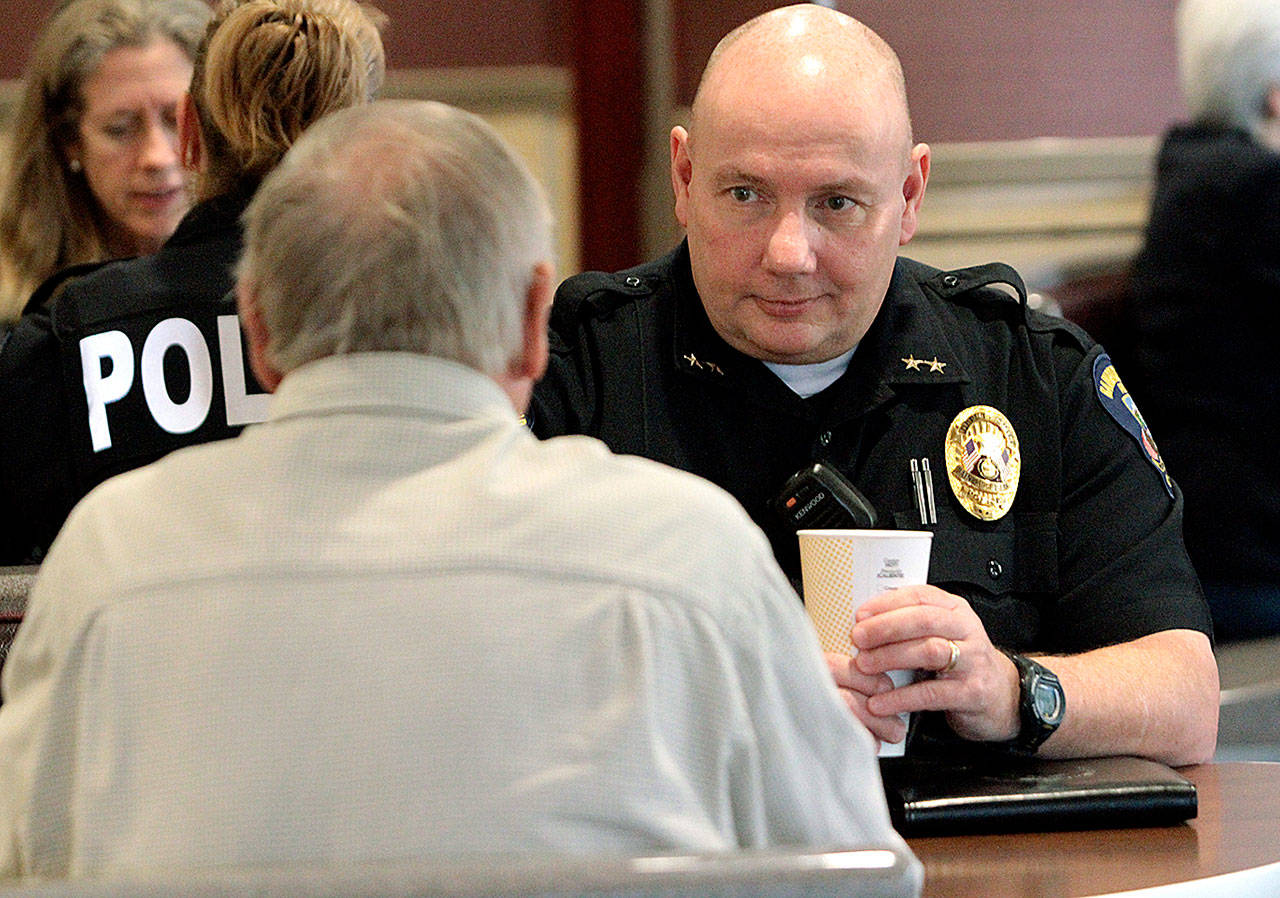 Bainbridge Police Chief Jeff Horn talks to an island resident last year during a session of the “Coffee with a Cop” program. (Brian Kelly | Bainbridge Island Review)