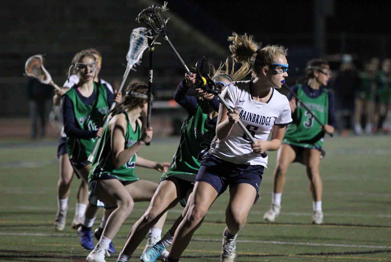 Eleanor Collins puts the pressure on during the Spartans’ matchup against Woodinville in girls varsity lacrosse. (Photo courtesy of Julie Fox)