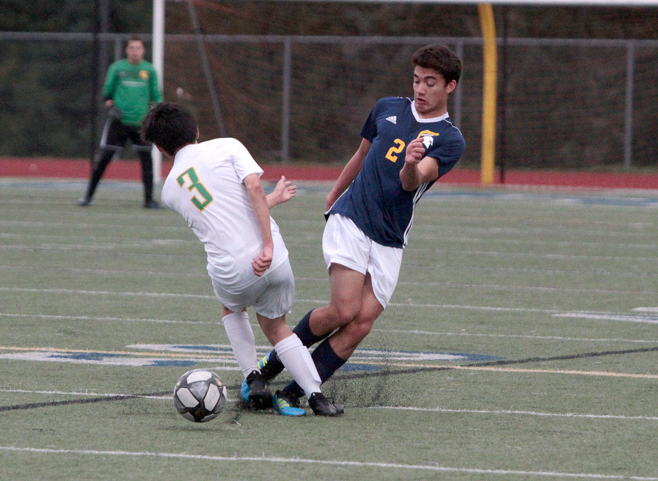Luciano Marano | Bainbridge Island Review - Spartan junior Nick Wolgamott semi-collides with a Bishop Blanchet player during a scramble for the ball last Friday.