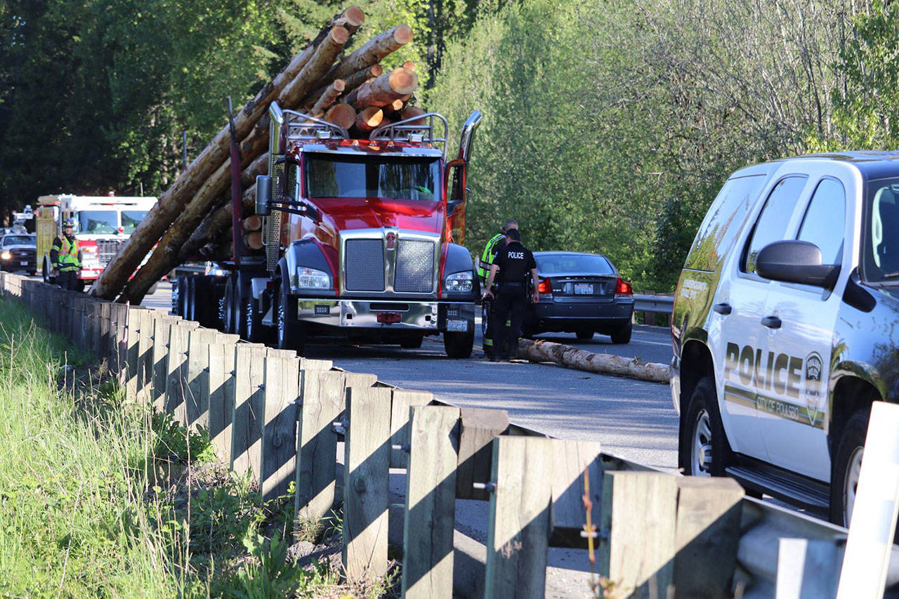 A log truck lost part of its load Monday in Poulsbo, stalling the morning commute on Highway 305. (Photo courtesy of the Poulsbo Fire Department)