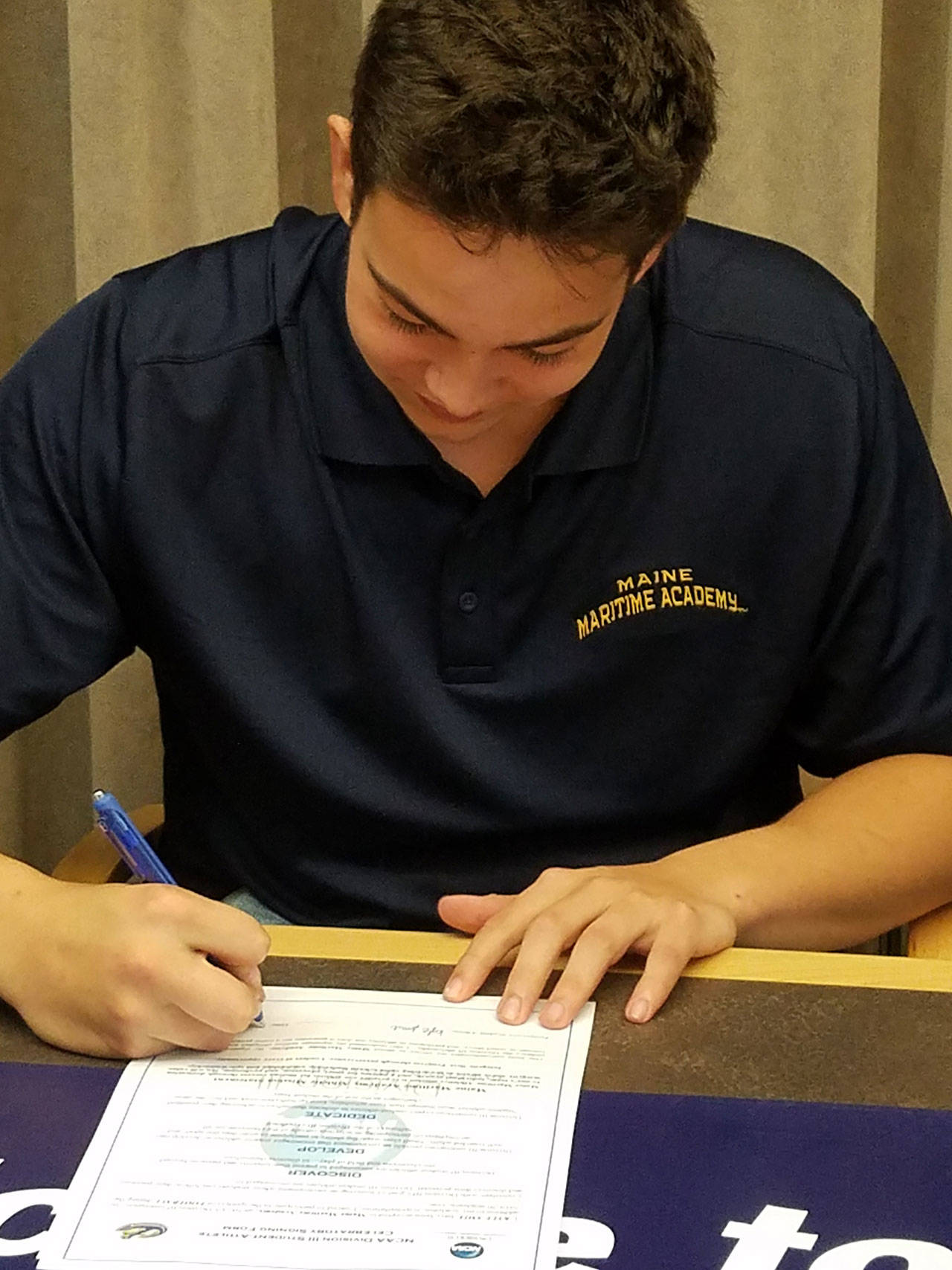 Kyle Smith signs his letter of intent. (Photo courtesy of Bainbridge High)