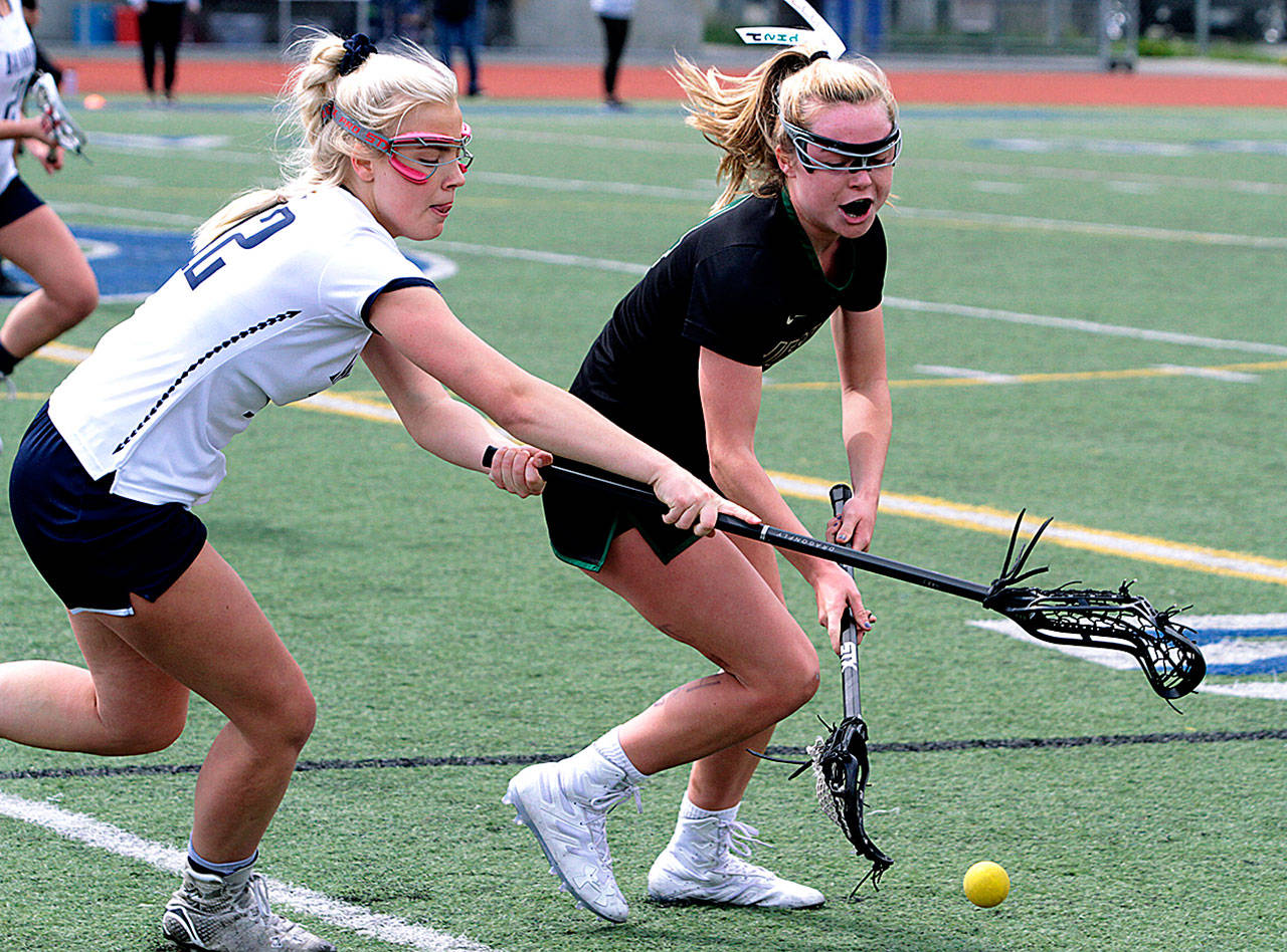Eleanor King hustles for a ground ball during the Spartans’ game against Jesuit at Bainbridge High’s Memorial Stadium. (Brian Kelly | Bainbridge Island Review)