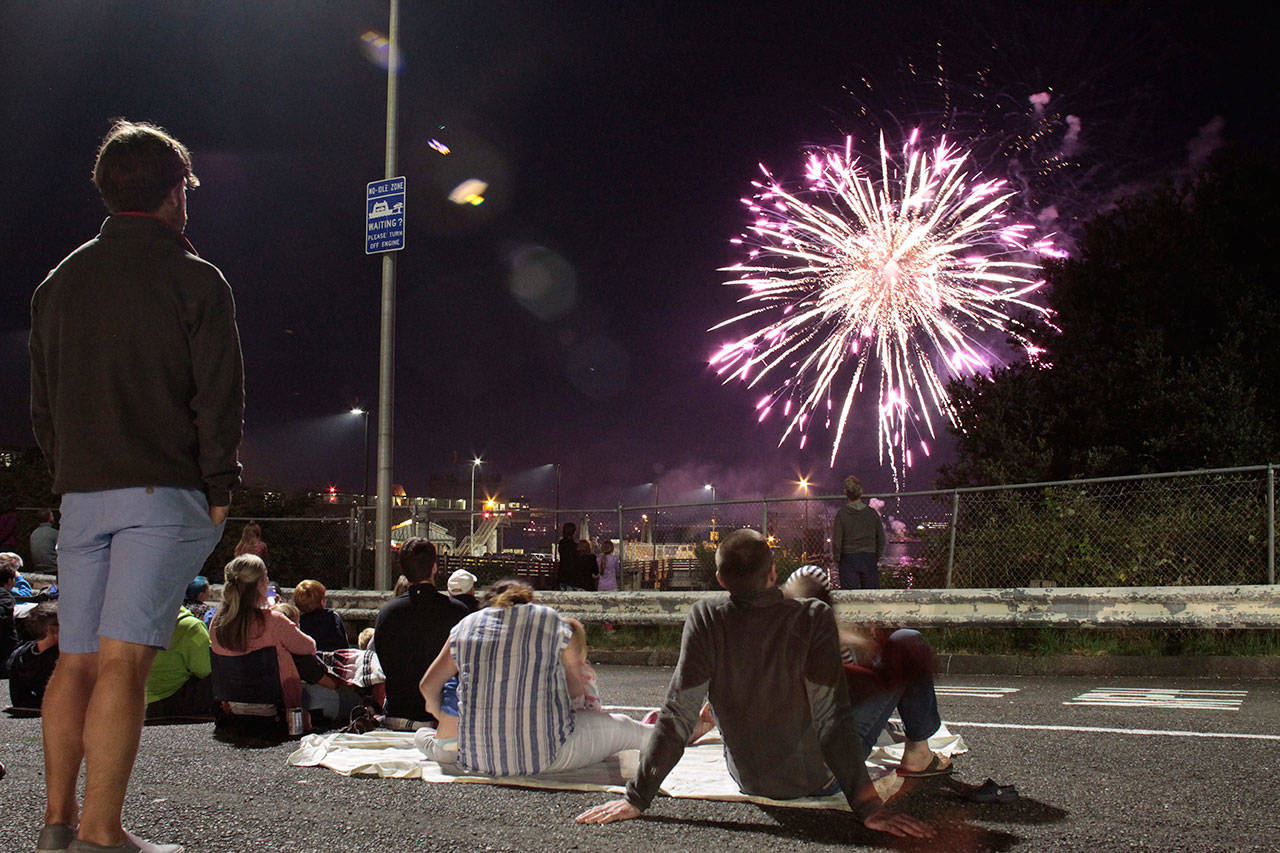 Luciano Marano | Bainbridge Island Review - A crowd gathers in the traffic lanes of the Winslow ferry terminal to watch the Grand Old Fourth fireworks show.
