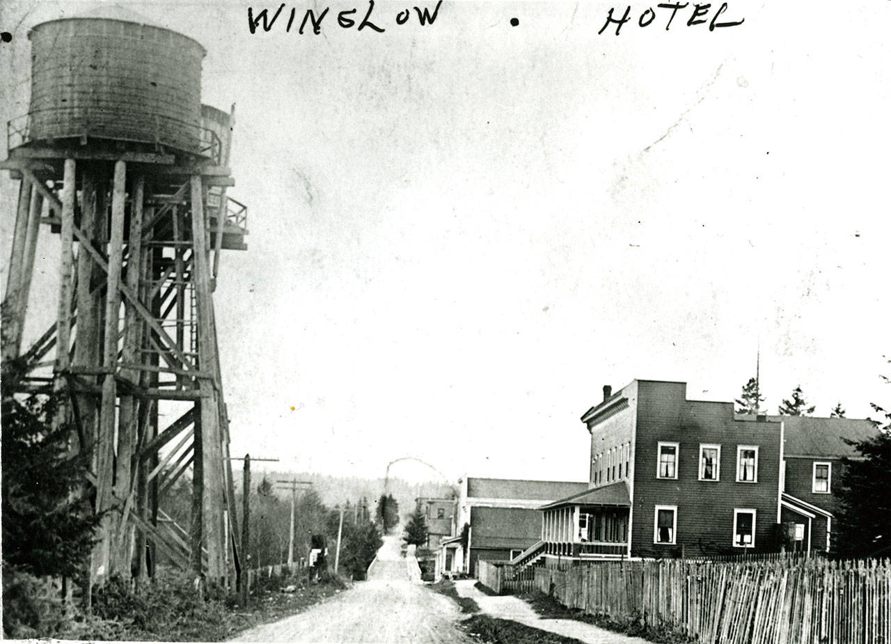 The original Winslow Hotel can be seen at right, across the street from two water towers. In the distance is the bridge over the gulch that split the downtown in half. (Photo courtesy of the Bainbridge Island Historical Museum)