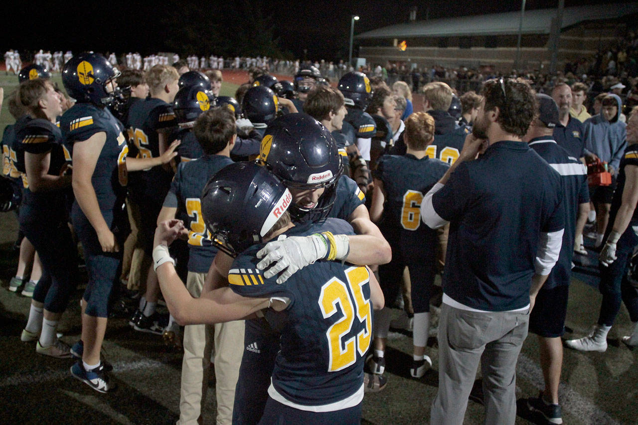 Luciano Marano | Bainbridge Island Review - Hugs and celebrating abounded on the field as the Bainbridge High varsity football team marked their winning of the Agate Cup last Friday.