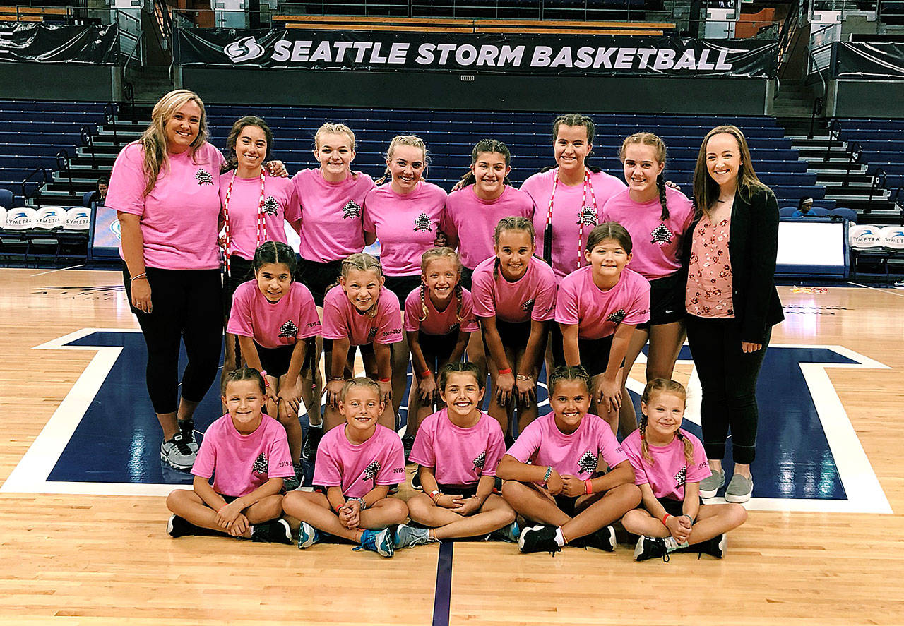 The Bainbridge Island Rope Skippers and their coaches gather for a team photo before their performance at a recent Seattle Storm WNBA basketball game. (Photo courtesy of the Bainbridge Island Rope Skippers)