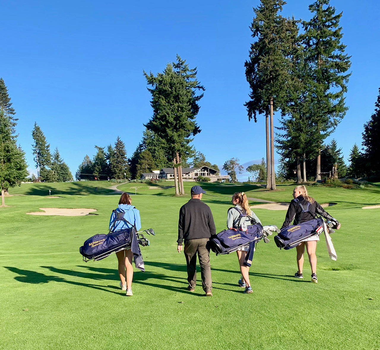 Sara havill photo | Spartan girls varsity golf team Head Coach Ian Havill treks back to the Wing Point Golf & Country Club clubhouse with several upperclassmen of this year’s squad after a recent match.