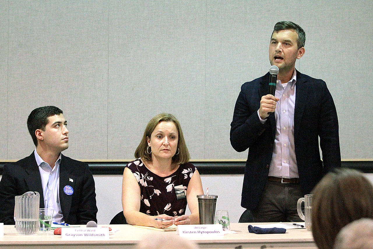 Anthony Oddo answers a question during Wednesday’s forum for city council candidates while fellow candidates Grayson Wildsmith and Kirsten Hytopoulos listen. (Brian Kelly | Bainbridge Island Review)