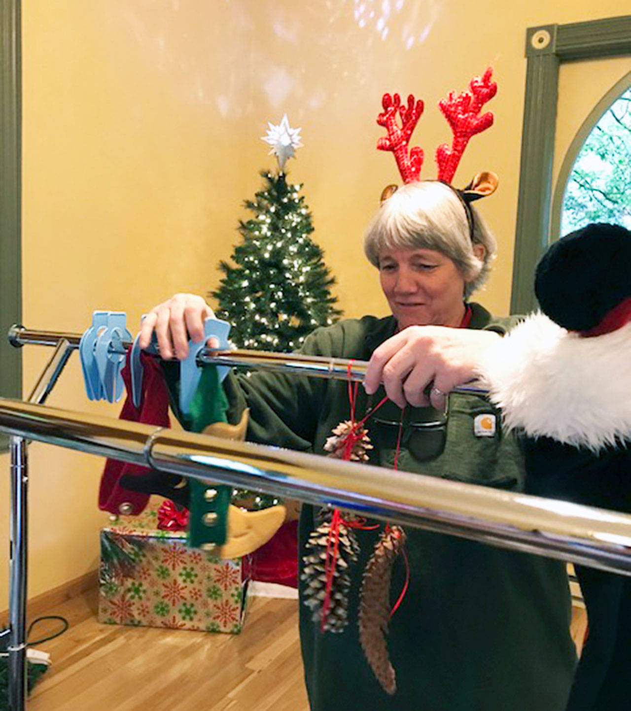 The Rev. Cindy Roberts gets into the holiday mood as she helps set up for the churchs annual holiday bazaar, planned this year for Saturday, Nov. 9. (Photo courtesy of Seabold Methodist Church)