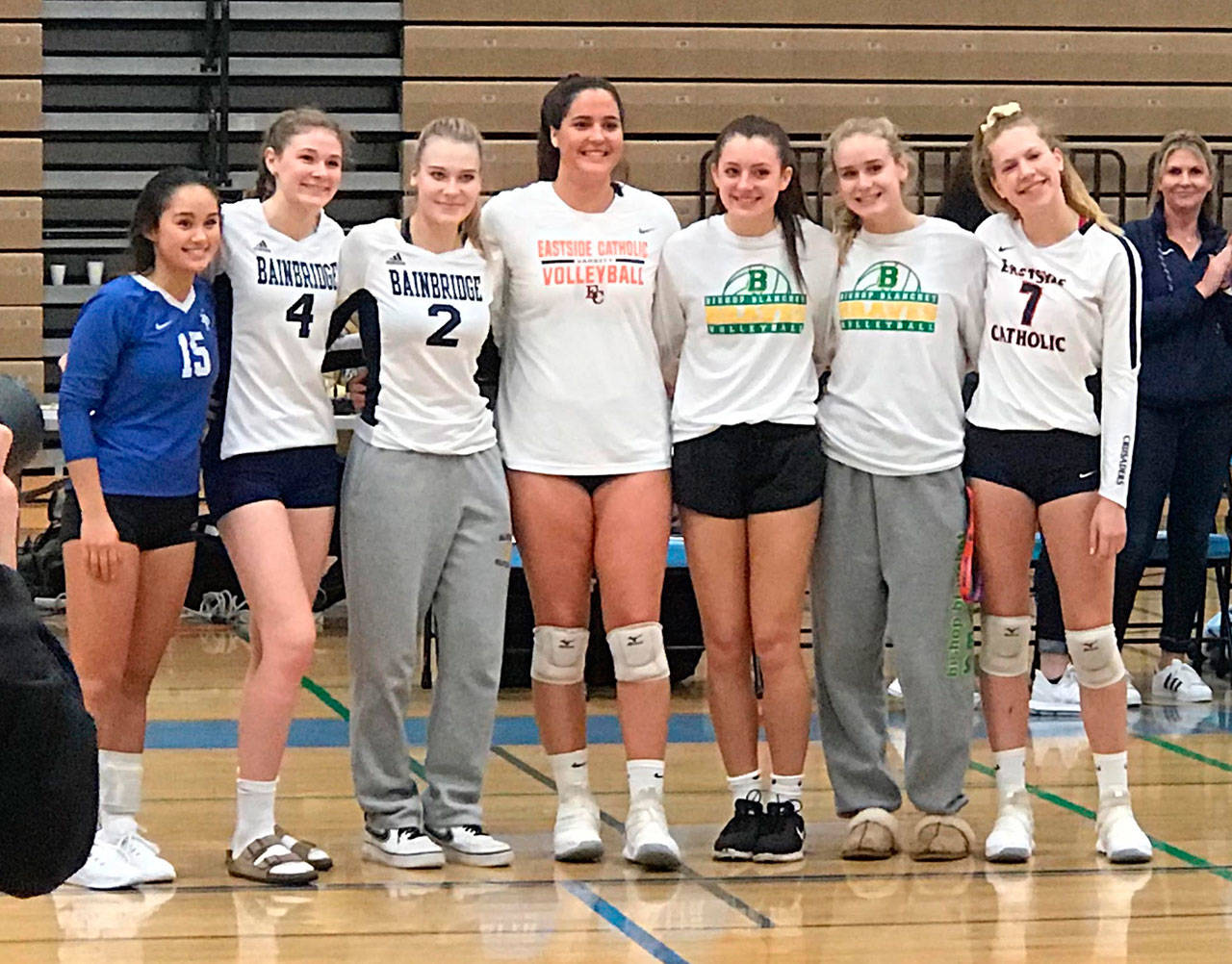 Paige Bouma and Rebecca Roman, second and third from left, earned post-season Metro League honors in volleyball. (Photo courtesy of Dominique Atherley)
