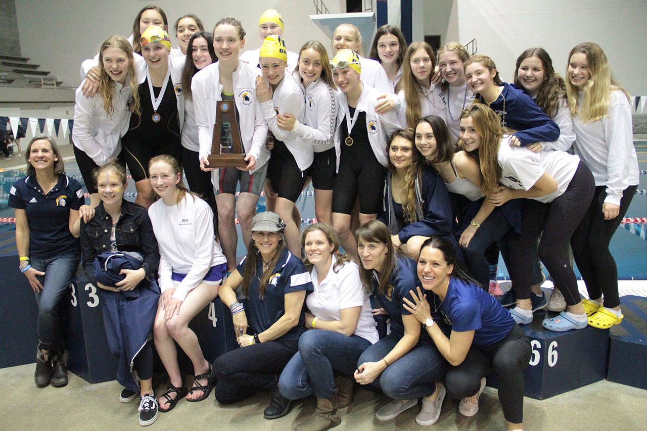 The Spartan girls swimming & diving team stands on the winners’ platform with the 3A third-place trophy. (Brian Kelly | Bainbridge Island Review)