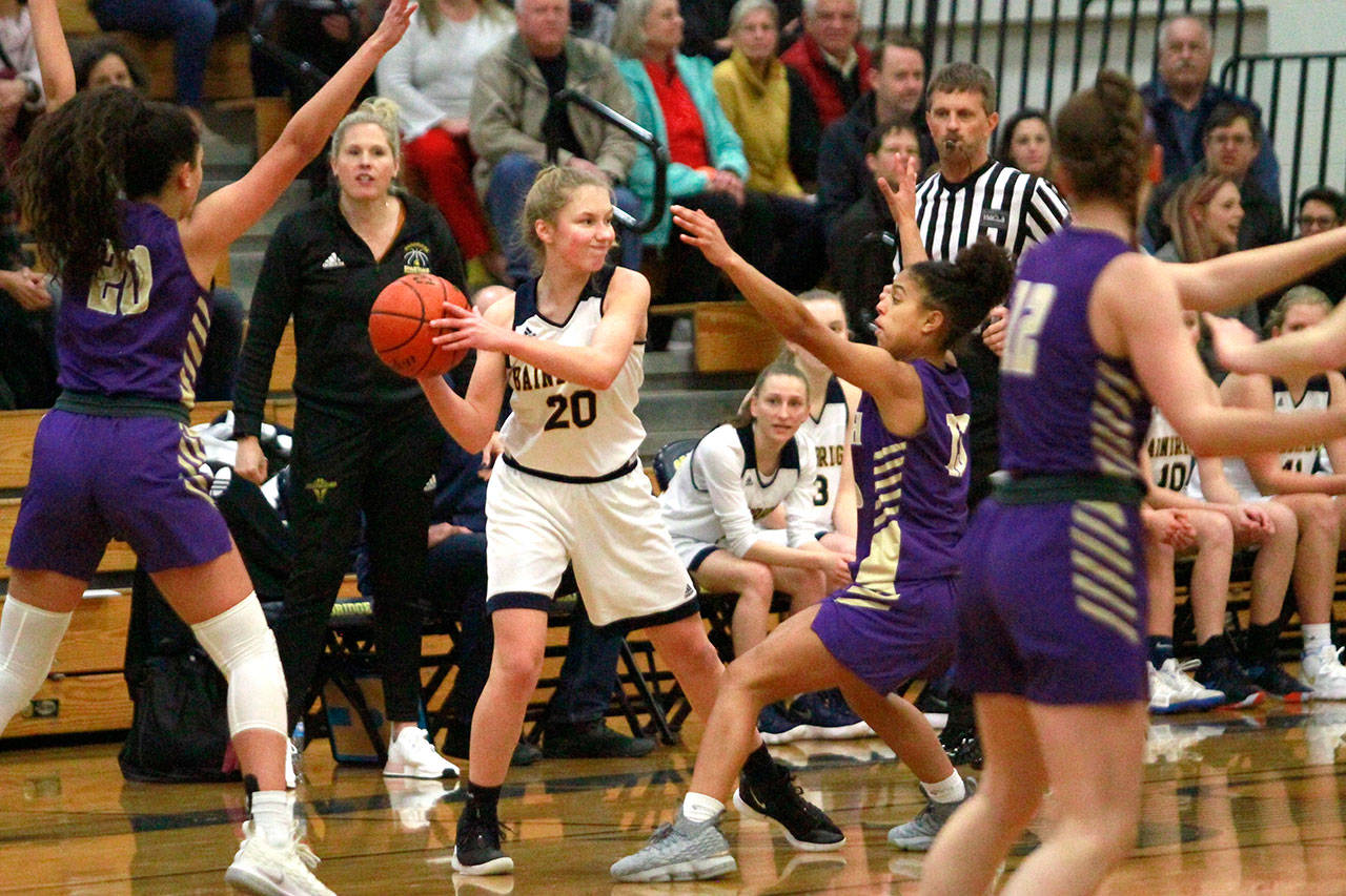 Spartan sophomore Grace Colburn looks to pass the ball in action against the Vikings Monday at Paski Gymnasium. (Luciano Marano | Bainbridge Island Review)