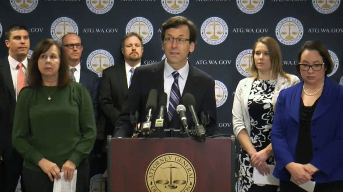 Washington State Attorney General Bob Ferguson (center) announced a lawsuit against Johnson Johnson in a press conference Thursday. He was joined by Debbie Warfield, of Everett (left) and Skagit County Commissioner Lisa Janicki (right), both of whom lost sons to opioids, and Rep. Lauren Davis, of Shoreline (second from right), founder of the Washington Recovery Alliance. (TVW)