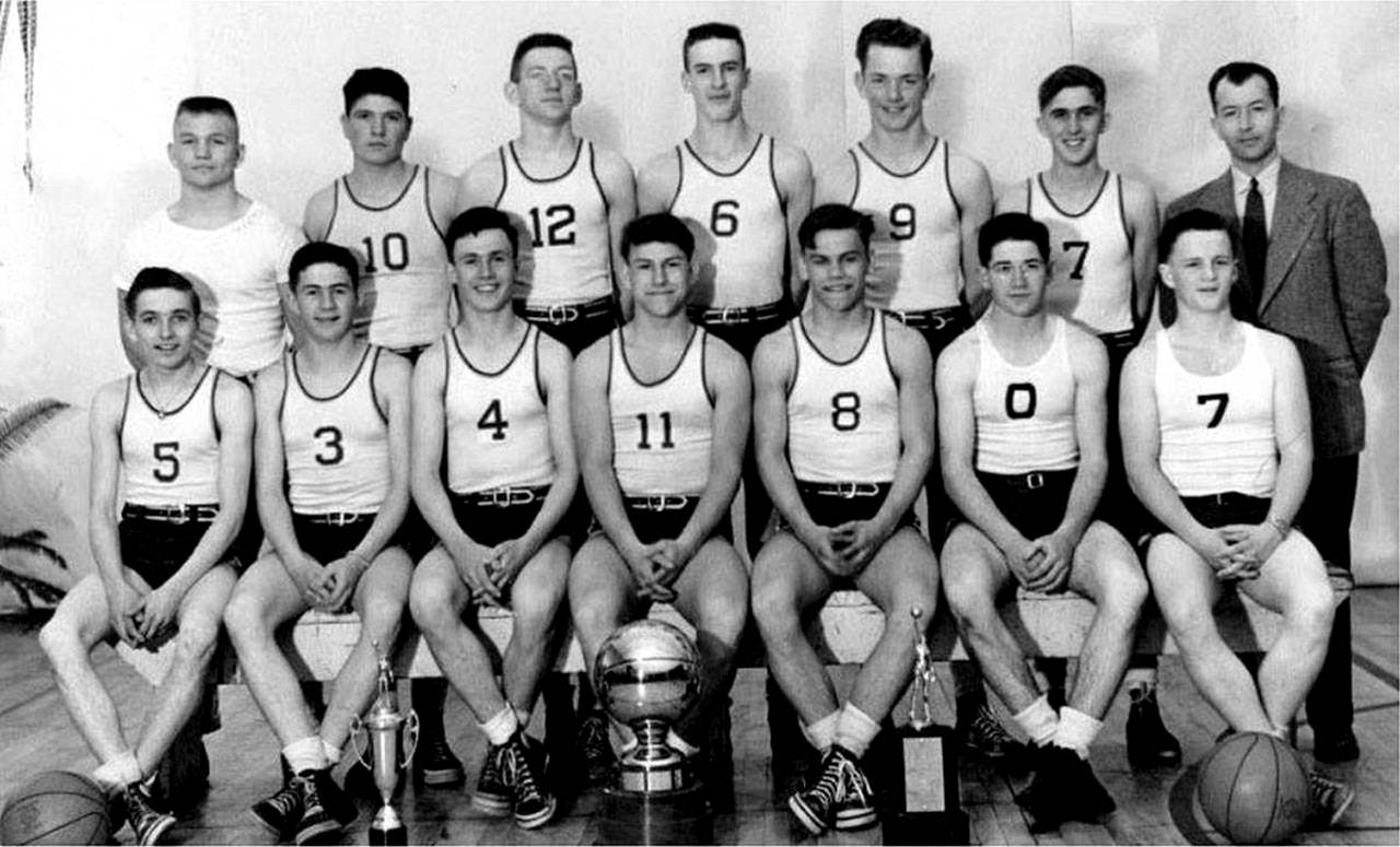 The 1948 Bainbridge boys state championship basketball team will be inducted into the Kitsap Athletic Roundtables Kitsap Sports Hall of Fame. Front row: Bob Sigle, Bob Buchanan, Dale Wallace, Don Nadeau, Jim Nadeau, Don Barnes, and Sam Clarke. Back row: Bob Dixon, Pete Uglesich, Bob Woodman, Jack Start, Bob Olsen, Ray Lowrie, and Coach Tom Paski.                                (Photo courtesy of Kitsap Athletic Roundtable)