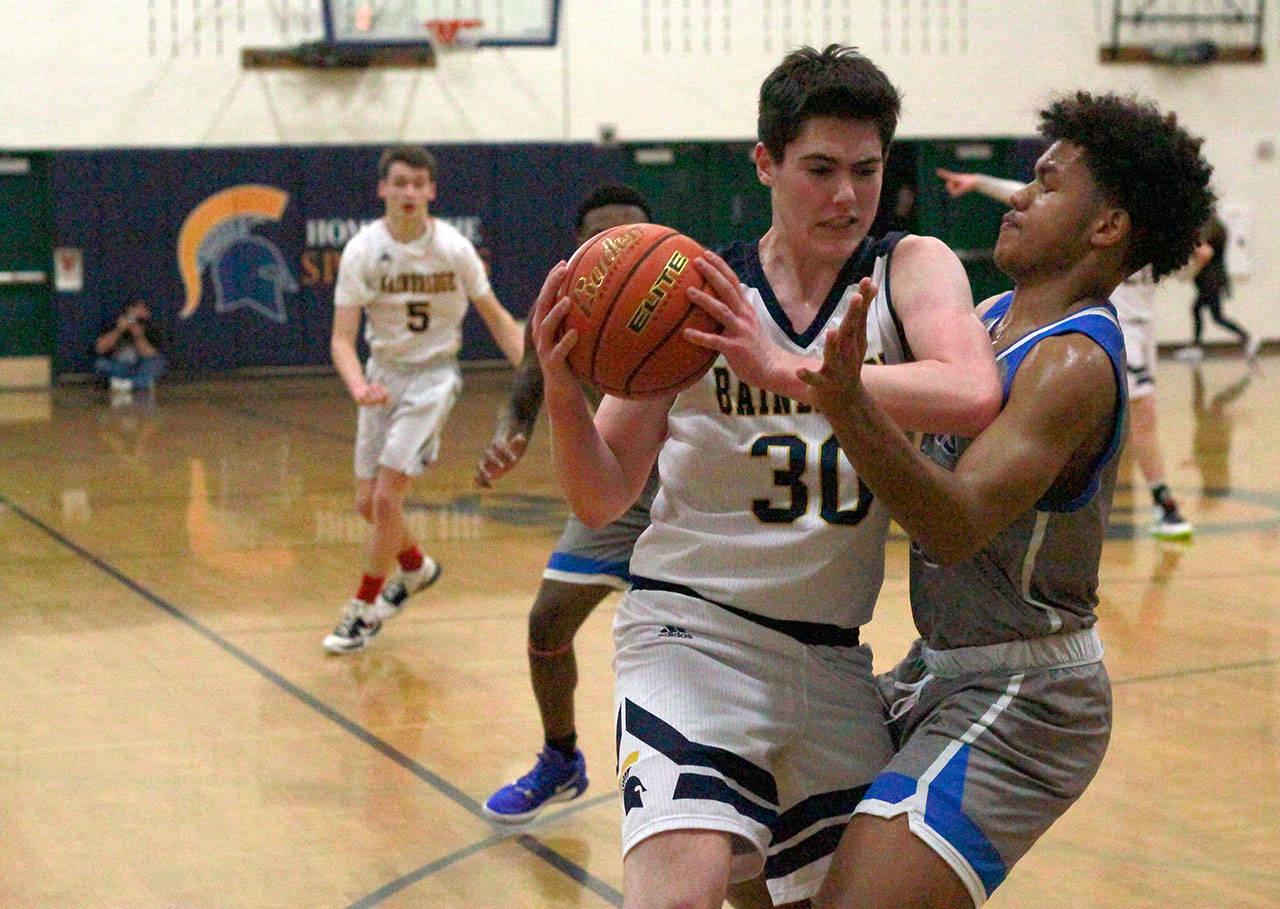 Luciano Marano | Bainbridge Island Review - Spartan sophomore James Carey attempts to work around an Ingraham defender near the net during last Friday’s home game.
