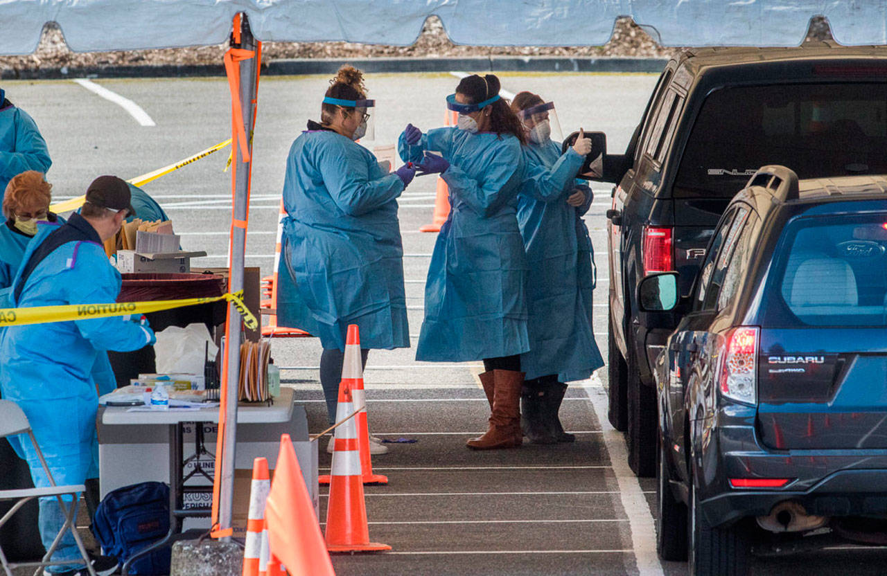 Drive-thru COVID-19 virus testing in the parking lot near Everett Memorial Stadium in Everett. (Andy Bronson | The Herald)