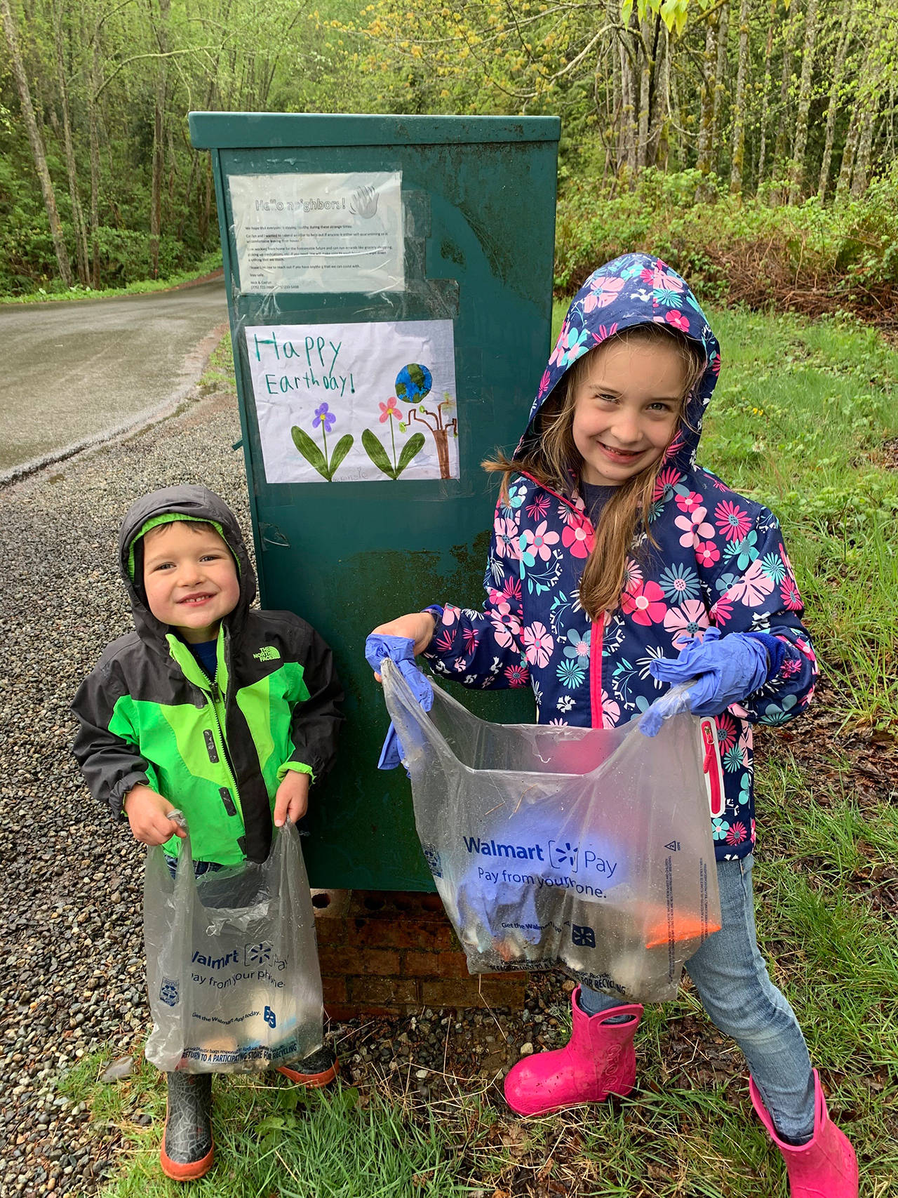 Rain did not stop trash collectors McKenzie Camarena, 6, and brother Corben, 4, during the pair’s celebration of Earth Day. Though students are learning at home due to the COVID-19 school closure, many continued the tradition at The Island School of taking part in environmentally friendly activities on Earth Day. (Photo courtesy of The Island School)