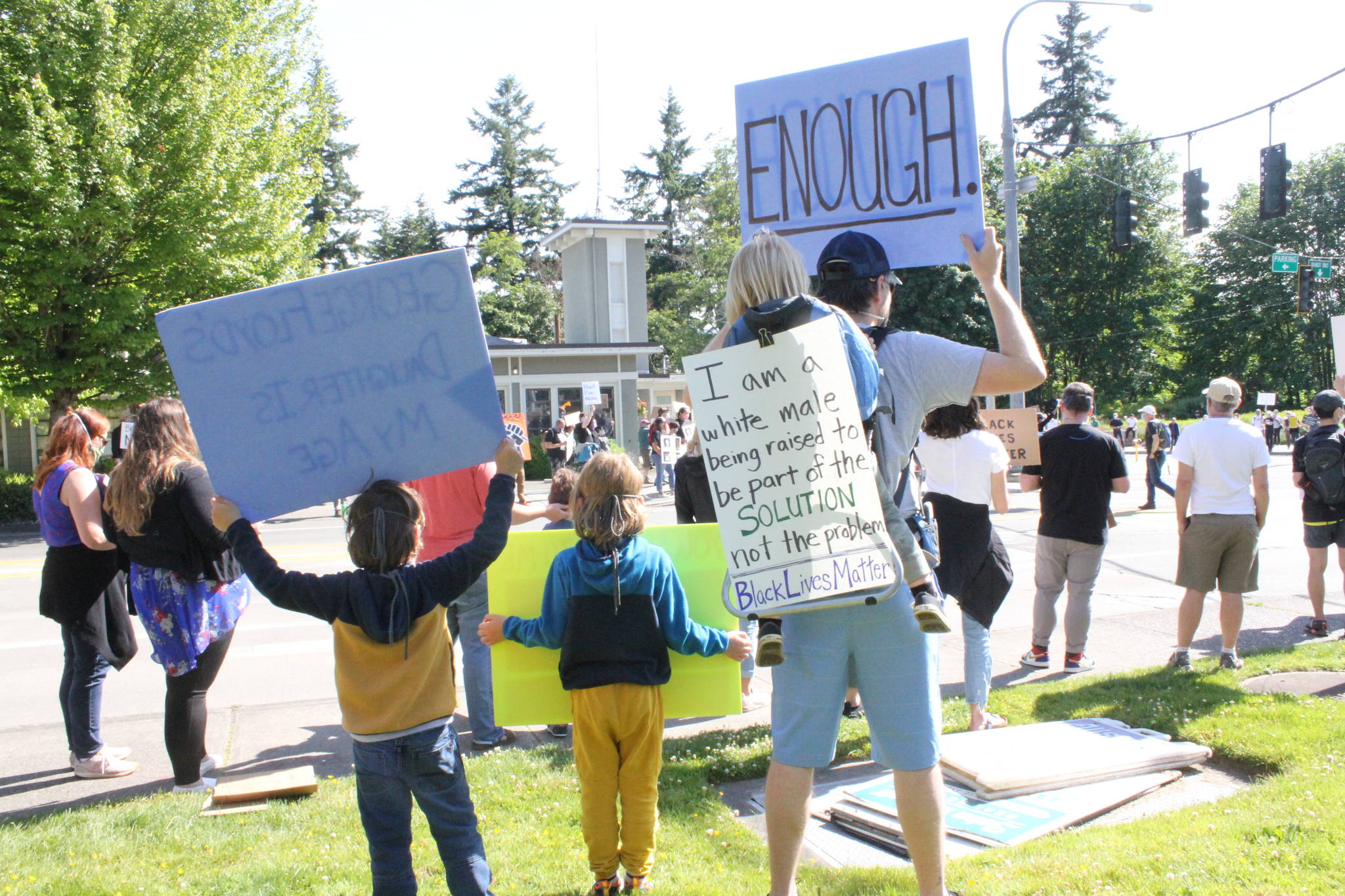 Protesters gather in Winslow as part of a demonstration organized by Kitsap ERACE Coalition. Photo by Nick Twietmeyer.