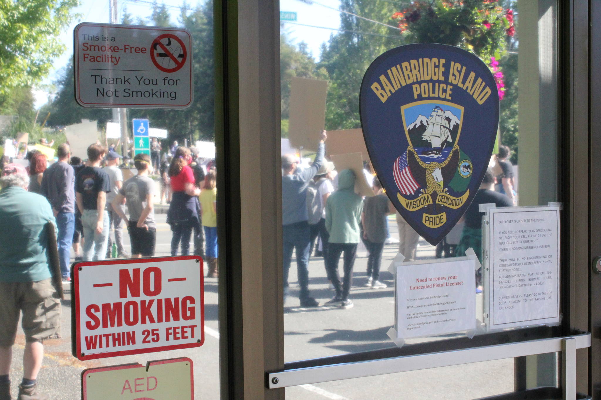 Protesters gather in front of the Bainbridge Island police station following the May 25 death of George Floyd at the hands of Minneapolis police. Photo by Nick Twietmeyer