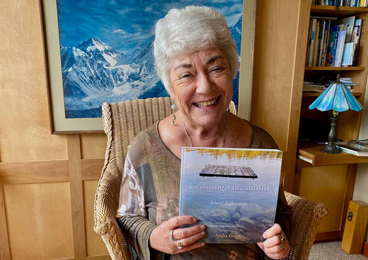 Photo courtesy of Amba Gale | Bainbridge Island leadership guru Amba Gale with her debut book “Crossing Thresholds,” a collection of poetry, prompts and photographs, available now.