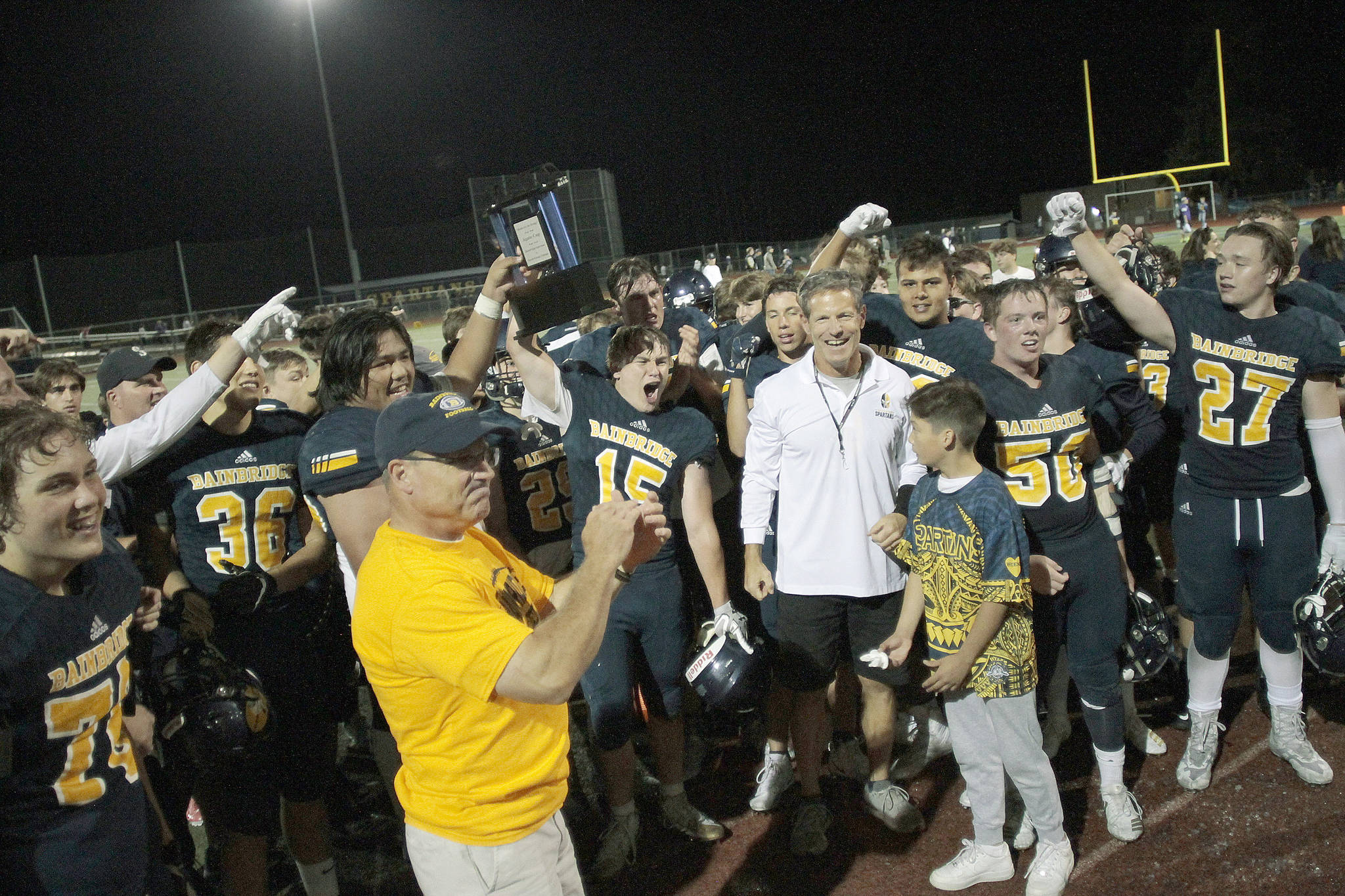The Bainbridge football team, shown here celebrating their 2019 Agate Cup win over North Kitsap, will have to wait until March of 2021 to get a chance to defend the cup. (Review file photo)